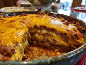 A close-up of a hearty Beef Taco Casserole with layers of seasoned ground beef and melted cheddar cheese.