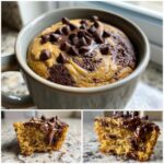 Close-up of a protein mug cake topped with peanut butter swirls and chocolate chips, showing a moist interior.