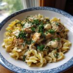 A close-up of creamy Chicken Garlic Parmesan Pasta topped with fresh parsley.