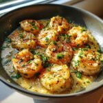 A close-up of succulent, perfectly cooked creamy garlic shrimp in a rich sauce, garnished with fresh parsley.
