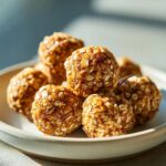 Close-up of a pile of homemade oatmeal protein balls, glistening and ready to eat.