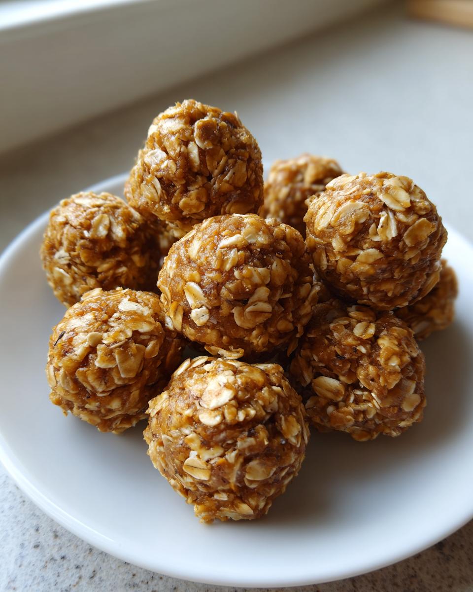 A close-up shot of a pile of delicious oatmeal protein balls on a white plate.