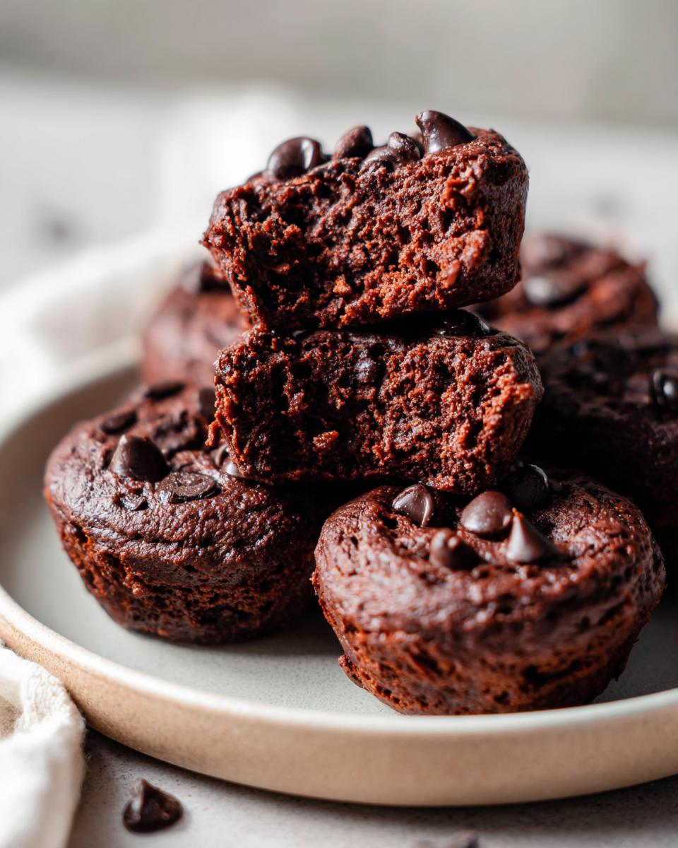 Stack of fudgy cottage cheese protein brownie bites topped with chocolate chips.
