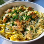 A bowl of creamy Garlic Parmesan chicken pasta topped with chopped parsley.