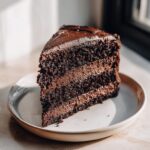 A decadent slice of dark chocolate layer cake, perfect for a Capricorn cake.