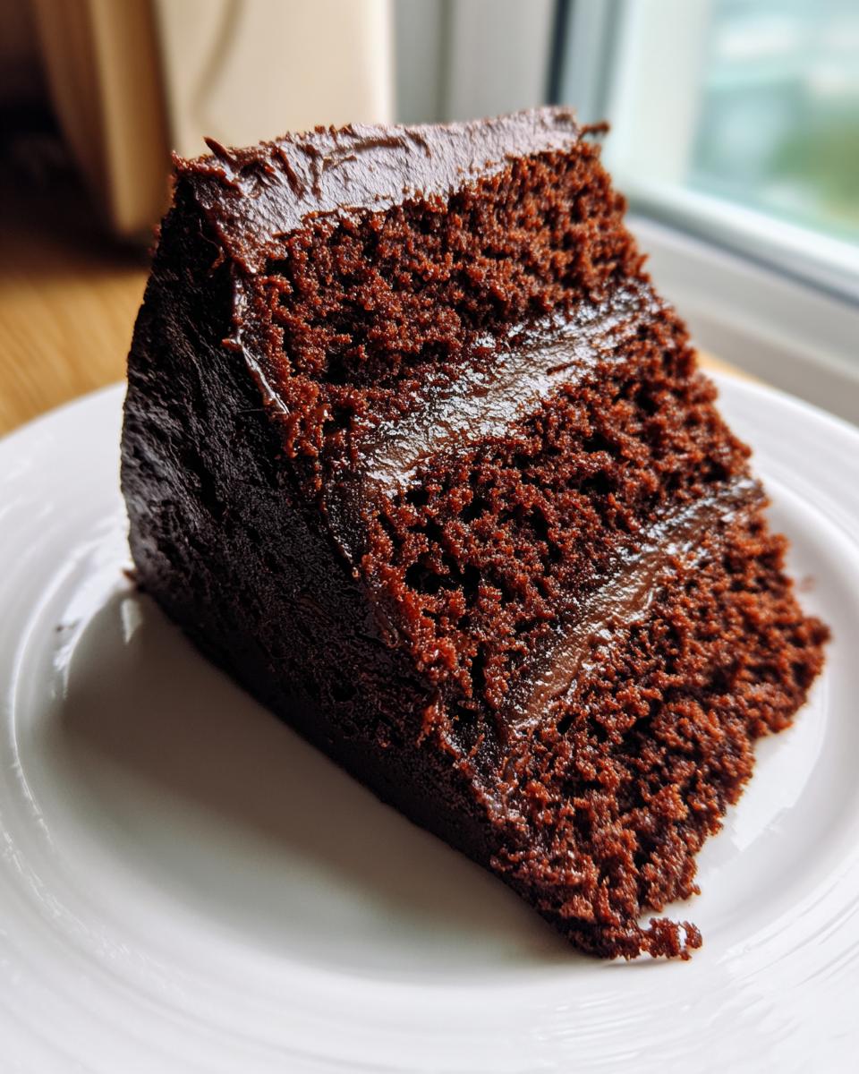 Close-up of a moist, dark chocolate cake slice, a potential Capricorn cake flavor.