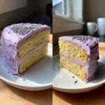 A cross-section slice of light yellow lavender cake with purple frosting and dried lavender sprinkles.